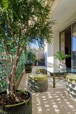 a patio with a palm tree and tables and chairs at Villa Lerins 411 by Halldis in Cannes