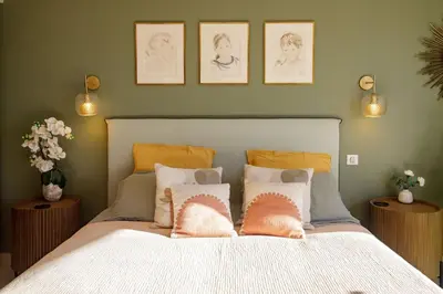 a bedroom with a bed with three pictures on the wall at Villa Lerins 411 by Halldis in Cannes