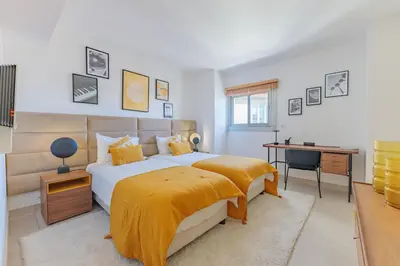 a bedroom with a large bed and a desk at Villa Lerins 304 by Halldis in Cannes