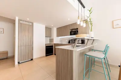 a kitchen with a counter and a stool in a room at Villa Lerins 304 by Halldis in Cannes
