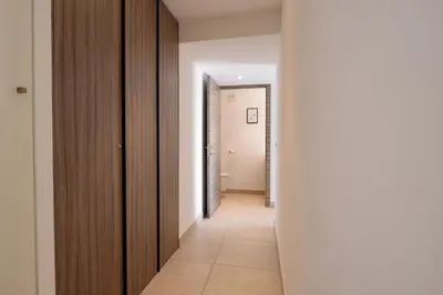 a hallway with white walls and a white floor and a hallway with a door at Villa Lerins 304 by Halldis in Cannes