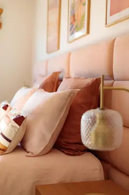 a bed with a bunch of pillows on it at Villa Lerins 304 by Halldis in Cannes