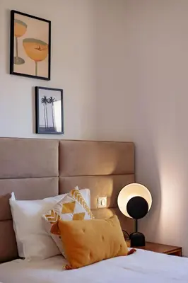 a bedroom with a bed with a brown headboard and a lamp at Villa Lerins 304 by Halldis in Cannes