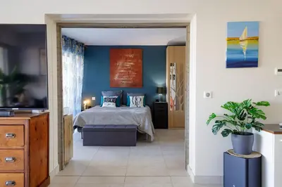 a bedroom with a bed with blue walls at Villa Lerins 405 by Halldis in Cannes