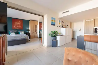 a living room with a bed and a kitchen at Villa Lerins 405 by Halldis in Cannes
