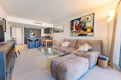 a living room with a couch and a table at Villa Lerins 401 by Halldis in Cannes