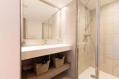 a bathroom with a sink and a shower at Villa Lerins 401 by Halldis in Cannes