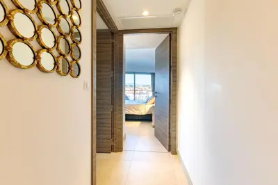 a hallway with a mirror and a door to a bedroom at Villa Lerins 401 by Halldis in Cannes