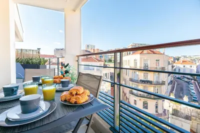 a table with food on a balcony with a view at Villa Lerins 401 by Halldis in Cannes
