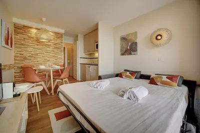 a bedroom with a large bed with towels on it at Vue Mer - Piscine - Tennis - 2P avec Jardin - Cannes in Cannes