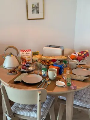 a table with a breakfast of food and a toaster at CasaMia Cannes - Exceptional Sea View, Pool, Beach in Cannes