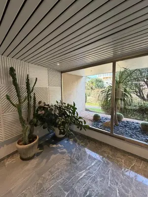 a room with a large window with plants in it at Charming studio 2 min from beach in La Celle-sous-Gouzon