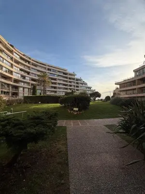 a large apartment building with a grassy yard in front at Charming studio 2 min from beach in La Celle-sous-Gouzon