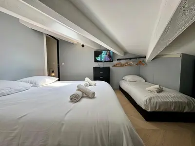two beds in a room with two towels on them at Appart 3 chambres, Cannes centre & plages in Cannes