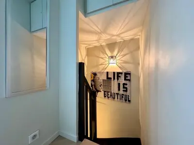 a hallway with a door with a sign on the wall at Appart 3 chambres, Cannes centre & plages in Cannes