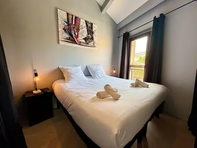 a bedroom with a bed with two towels on it at Appart 3 chambres, Cannes centre & plages in Cannes