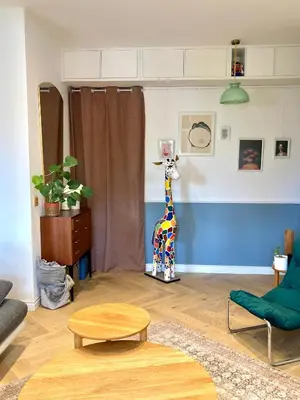 a living room with a giraffe standing in a room at Terrasse des artistes - Appartement 2 pièces avec pergola in Cannes