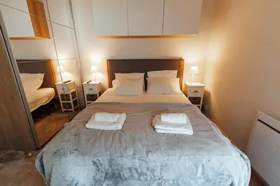 a bedroom with a large bed with two towels on it at Private Garden Hideaway by the Sea in Cannes