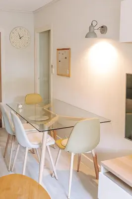 a dining room with a glass table and chairs at Private Garden Hideaway by the Sea in Cannes