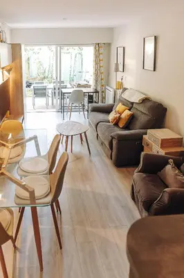 a living room with a couch and a table at Private Garden Hideaway by the Sea in Cannes