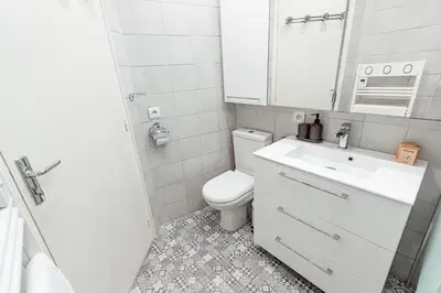 a bathroom with a toilet and a sink and a mirror at Private Garden Hideaway by the Sea in Cannes
