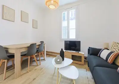 a living room with a couch and a table at Magnifique 2 pièces au Suquet in Cannes