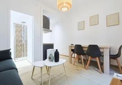 a living room with a couch and a table and chairs at Magnifique 2 pièces au Suquet in Cannes