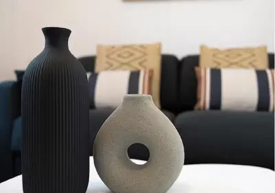 two vases sitting on a table in a living room at Magnifique 2 pièces au Suquet in Cannes