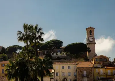 a clock tower on top of a city with a building at Magnifique 2 pièces au Suquet in Cannes