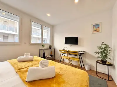 a bedroom with a large bed and a desk at Cannes One bedroom Apartment - M10 in Cannes