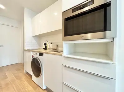 a kitchen with a microwave and a washer and dryer at Cannes One bedroom Apartment - M10 in Cannes