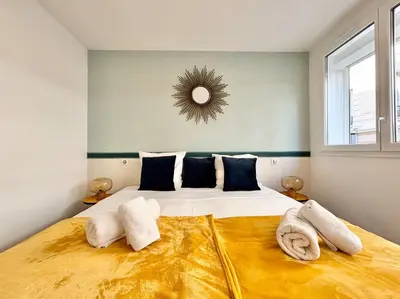 a bedroom with a large bed with towels on it at Cannes One bedroom Apartment - M10 in Cannes