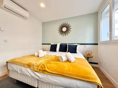 a bedroom with a large bed with towels on it at Cannes One bedroom Apartment - M10 in Cannes