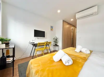 a bedroom with a yellow bed with a desk at Cannes One bedroom Apartment - M10 in Cannes