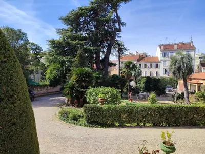 a park with trees and bushes and a building at Pearl Studio by Halldis in Cannes