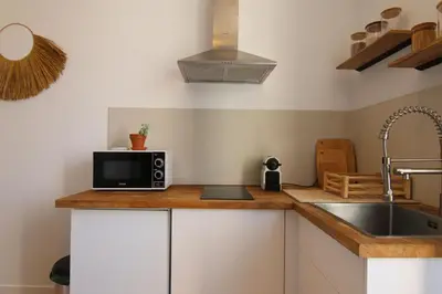 a kitchen with a sink and a microwave at Pearl Studio by Halldis in Cannes