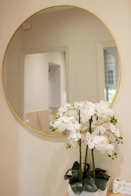 a vase with white flowers in front of a mirror at Écrin de charme à 2 pas de la Croisette & Palais in Cannes