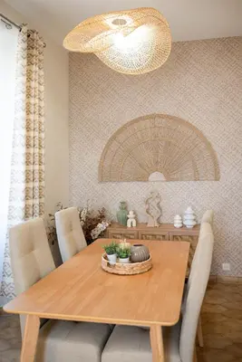a dining room with a wooden table with chairs at Écrin de charme à 2 pas de la Croisette & Palais in Cannes