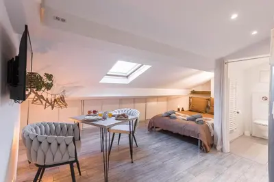 a room with a bed and a table and chairs at Studio Meynadier by Halldis in Cannes