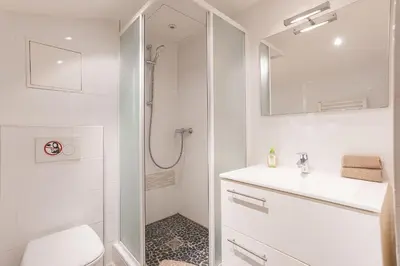 a white bathroom with a sink and a shower at Studio Meynadier by Halldis in Cannes