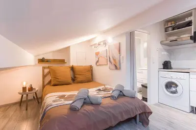 a bedroom with a bed and a washing machine at Studio Meynadier by Halldis in Cannes