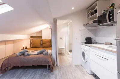 a small bedroom with a bed and a bathroom at Studio Meynadier by Halldis in Cannes