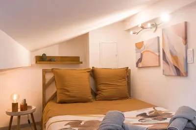a small bedroom with a bed and a table at Studio Meynadier by Halldis in Cannes