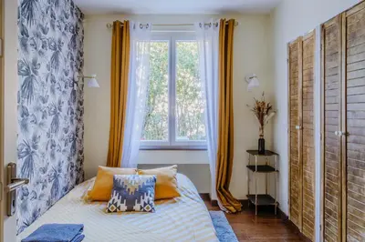 a bedroom with a bed and a window at Quiet Beach Cannes in Cannes