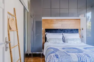 a bedroom with a bed with a wooden headboard at Quiet Beach Cannes in Cannes