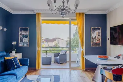 a living room with blue walls and a blue couch at Quiet Beach Cannes in Cannes