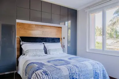 a bedroom with a large bed and a window at Quiet Beach Cannes in Cannes