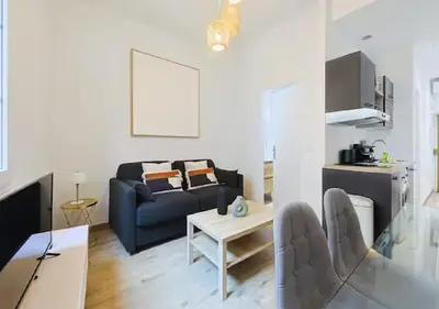 a living room with a couch and a table at Charmant deux pièces au Suquet in Cannes