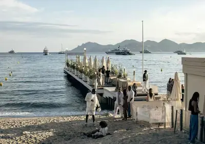 a group of people standing on a dock on the beach at Charmant deux pièces au Suquet in Cannes