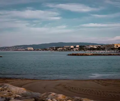 a large body of water with buildings in the background at Charmant deux pièces au Suquet in Cannes
